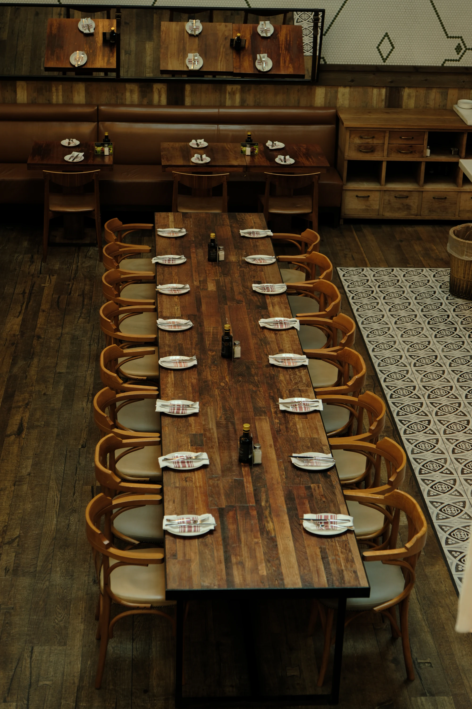 Long wooden table set with plates for a large group meal