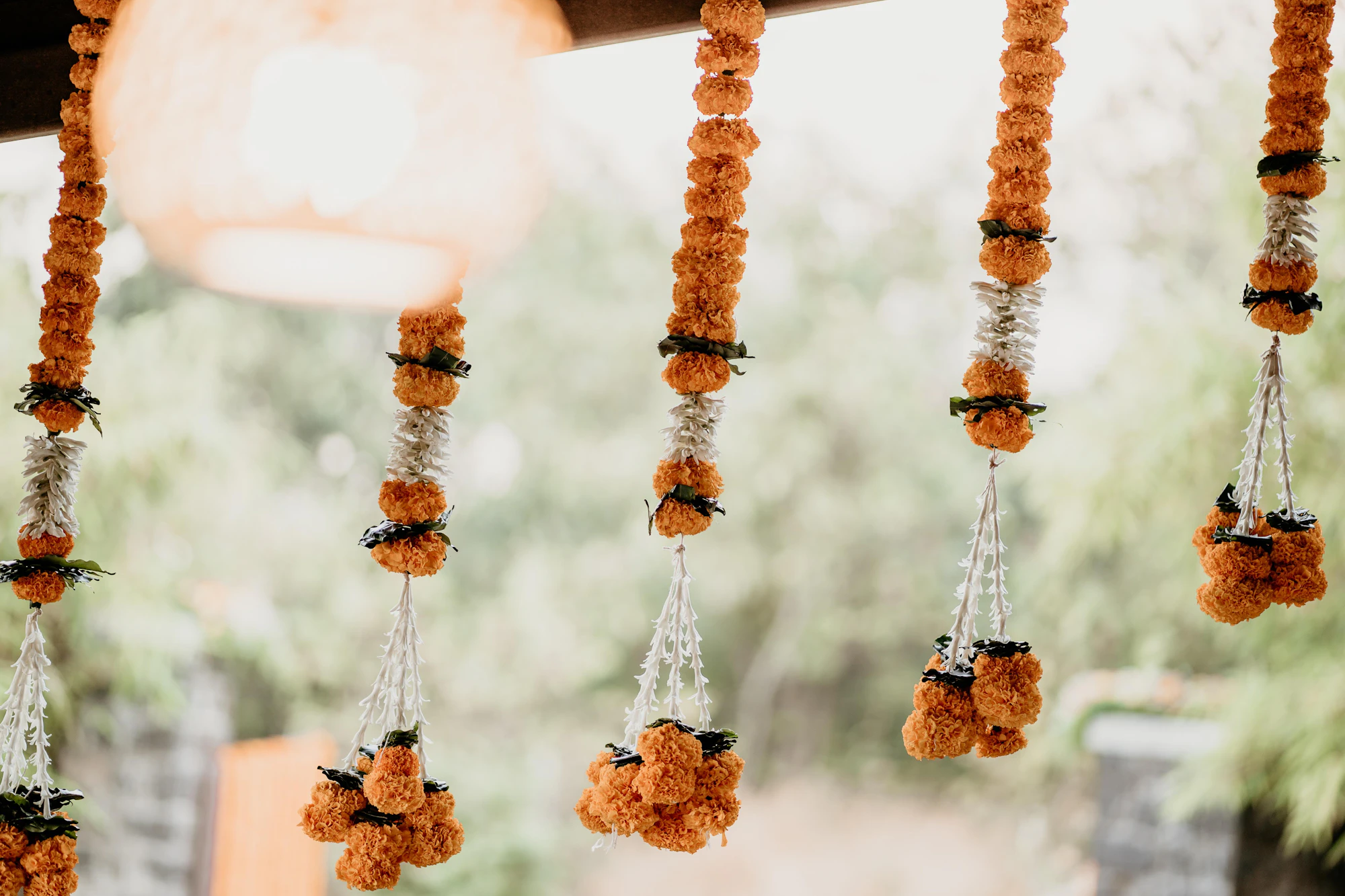 Marigold and jasmine garlands hanging in a row