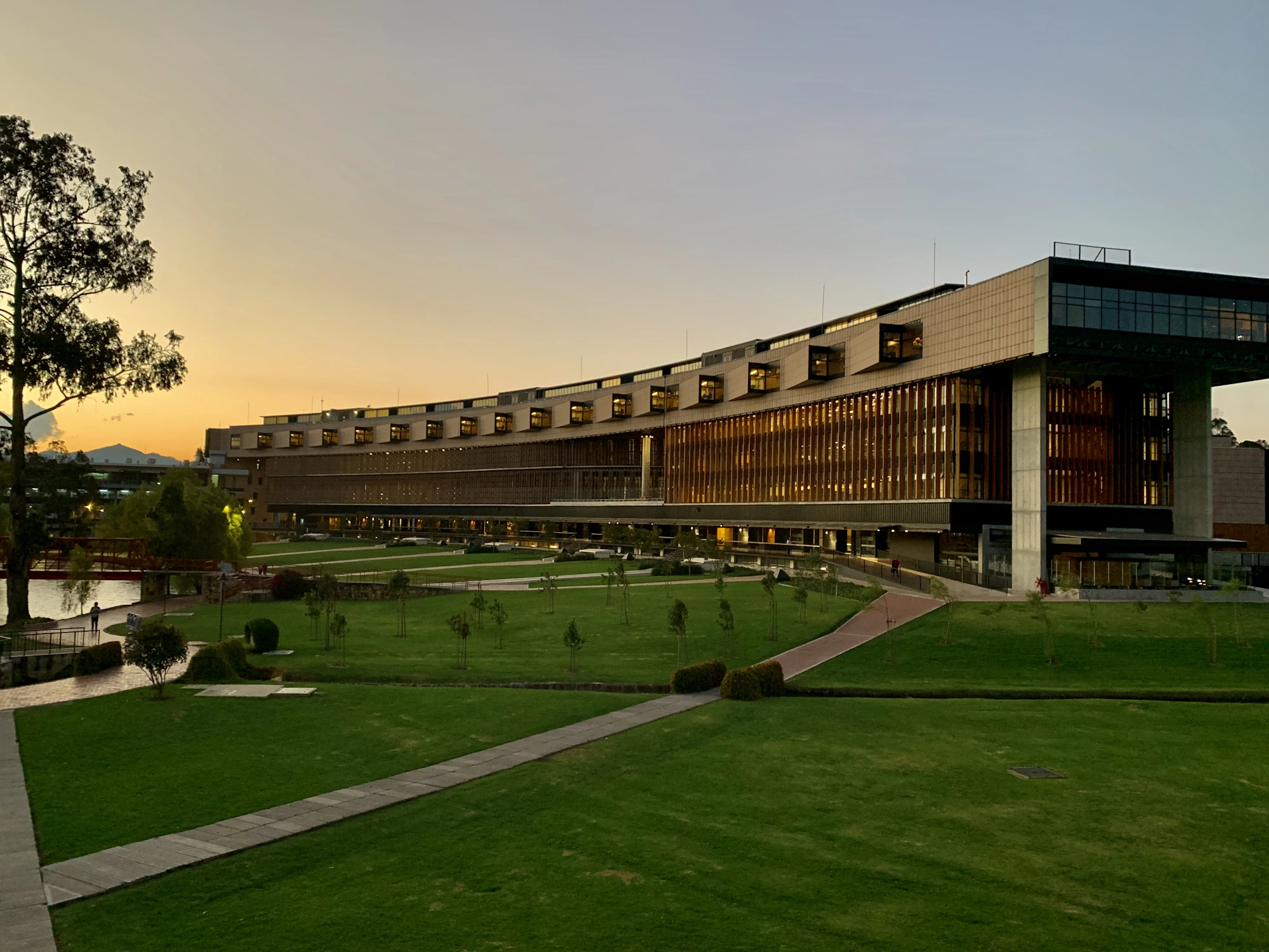 A campus building and lawns at dusk