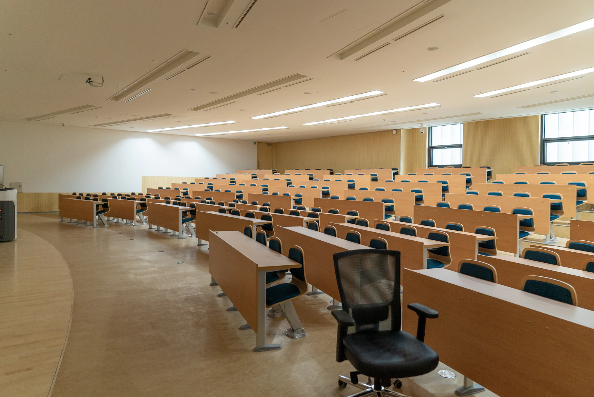 Rows of desks in an empty lecture hall