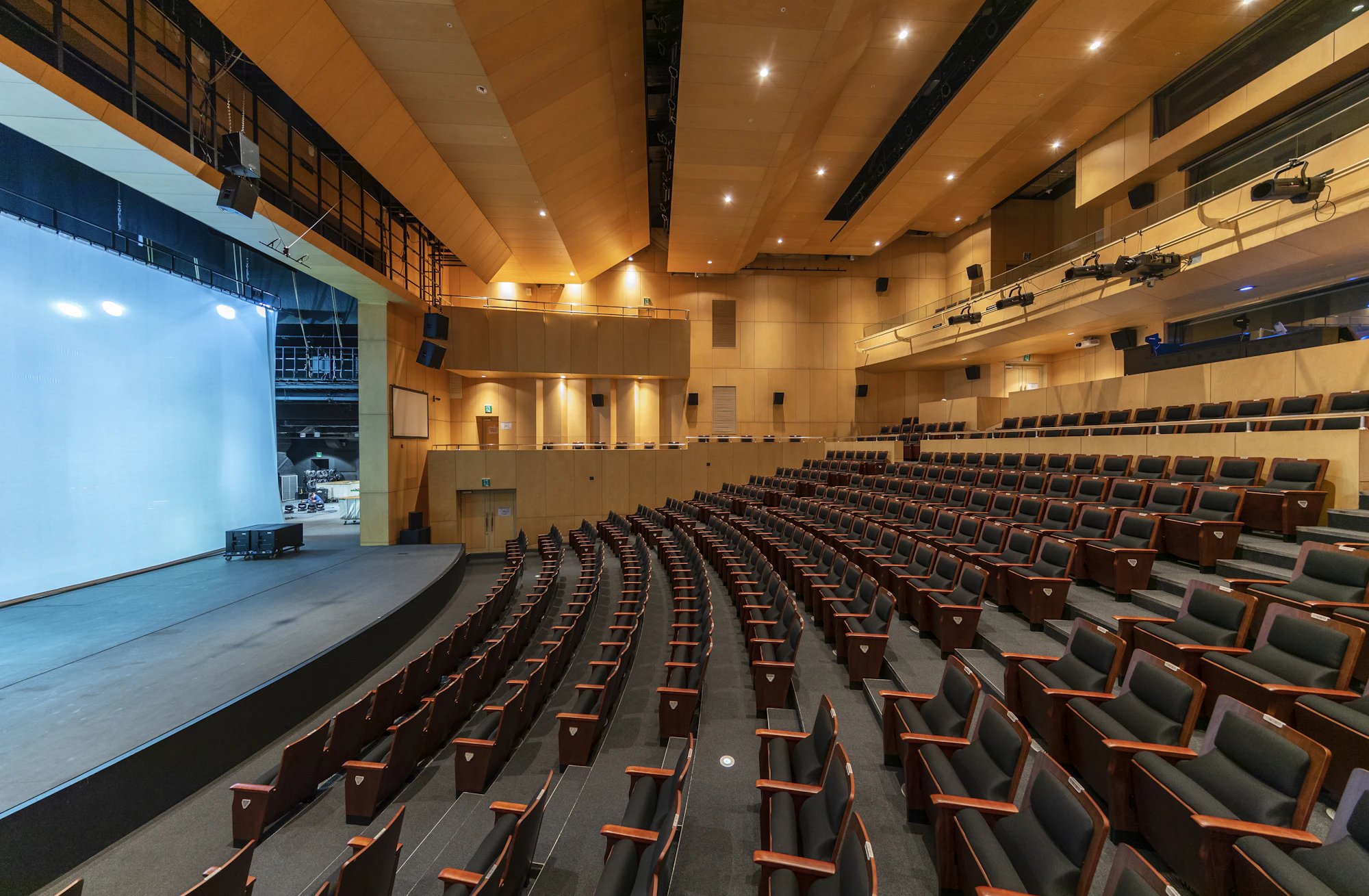 A large auditorium with a stage and tiered seating