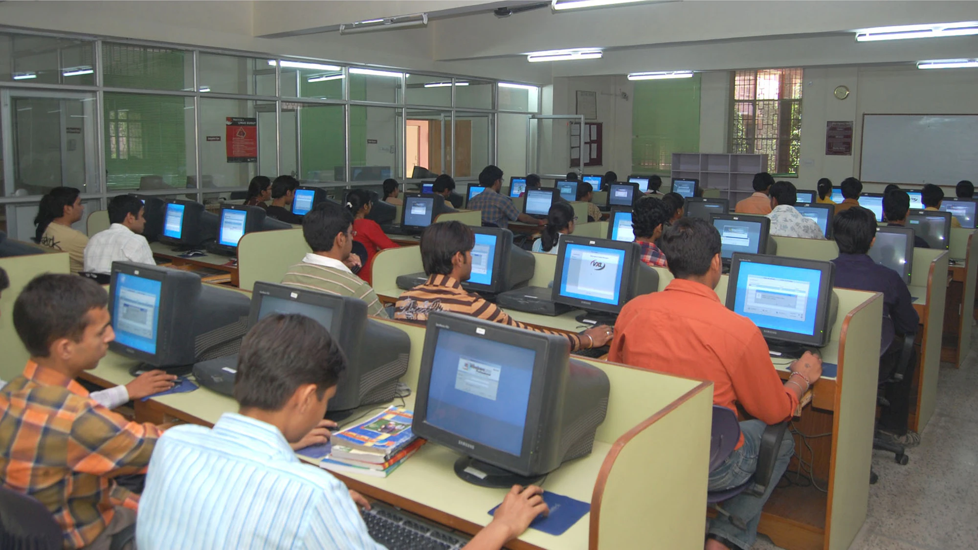 Students working at computers in a large lab