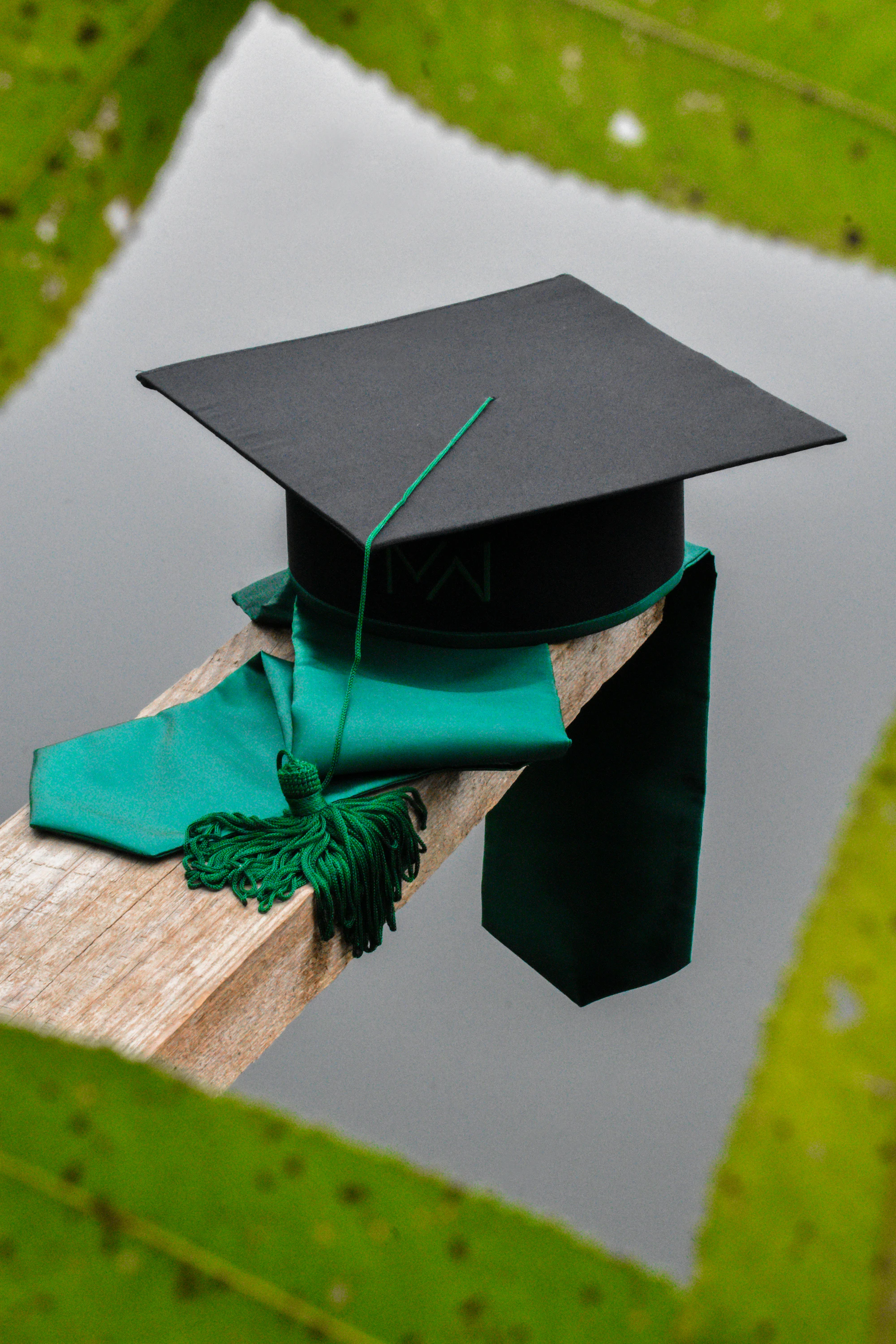 A graduation cap with a green tassel