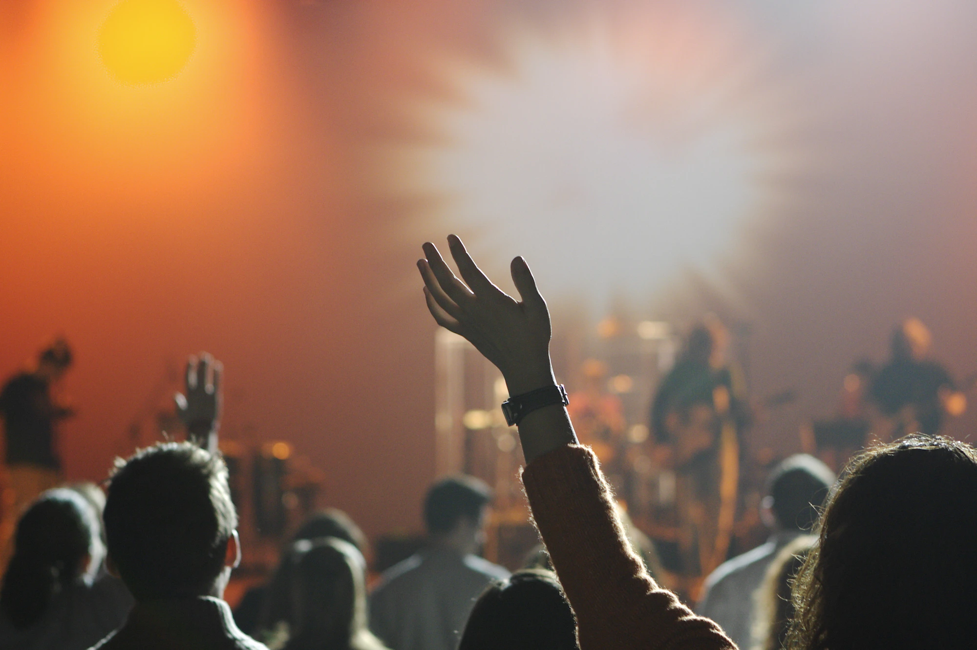 A raised hand during a worship gathering