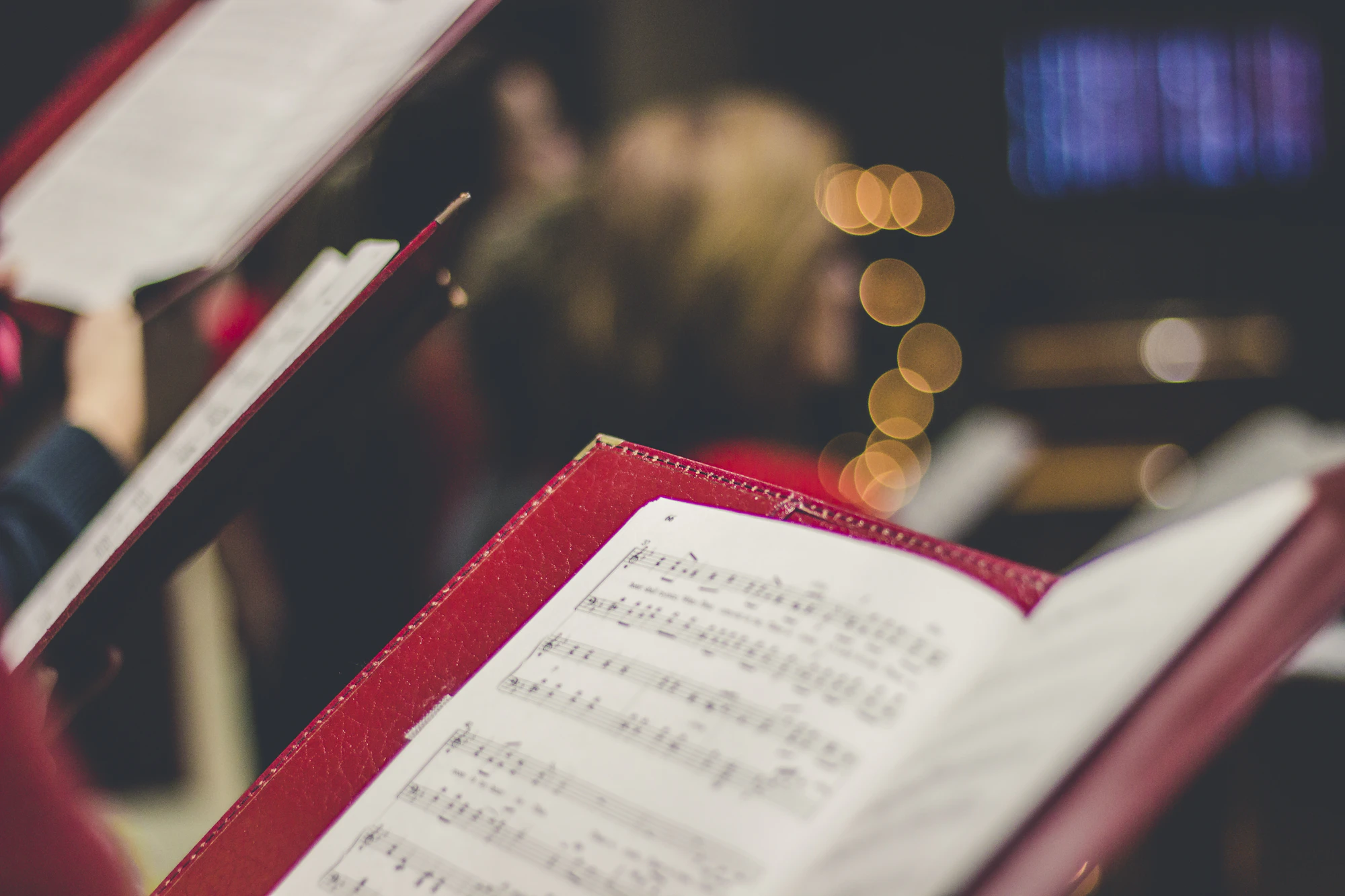 Choir members holding open music scores
