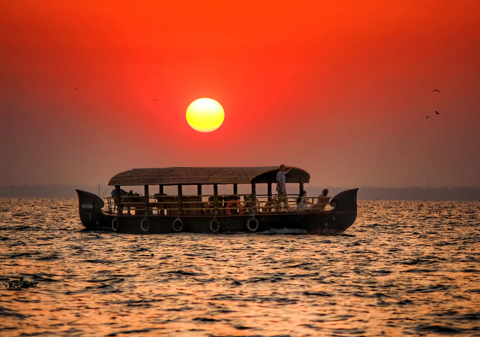 A boat silhouetted on the backwater at sunset