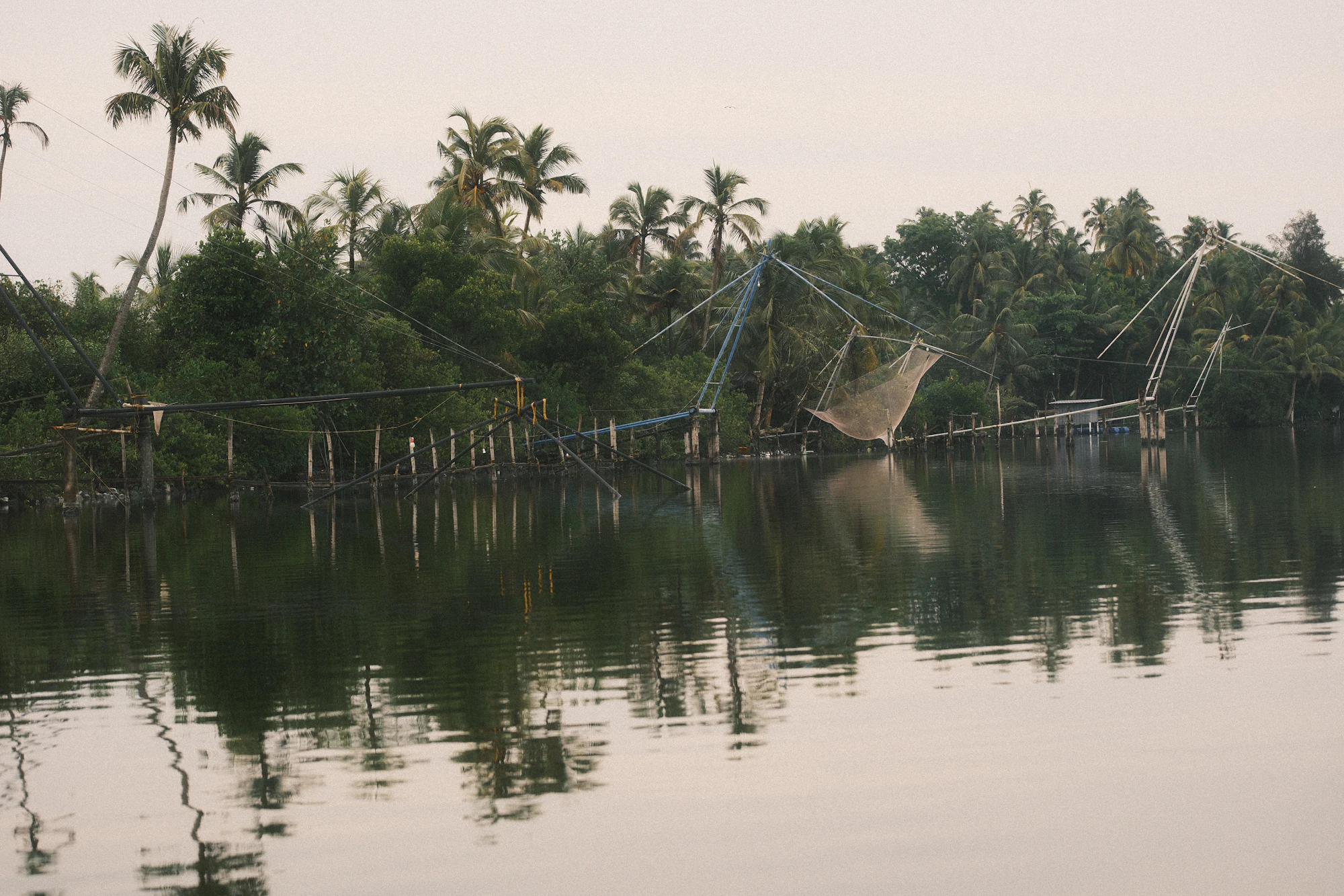 Chinese fishing nets on wooden frames over calm water
