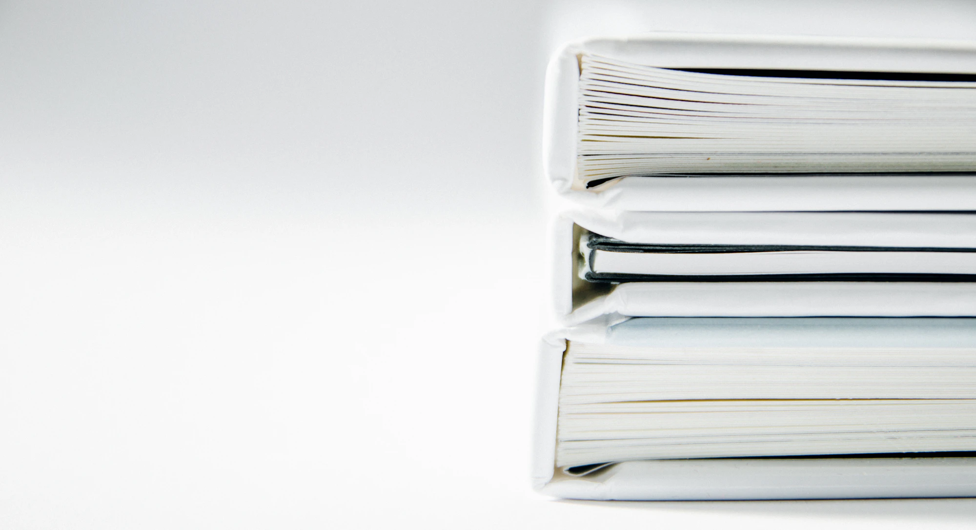 Stack of thick white folders