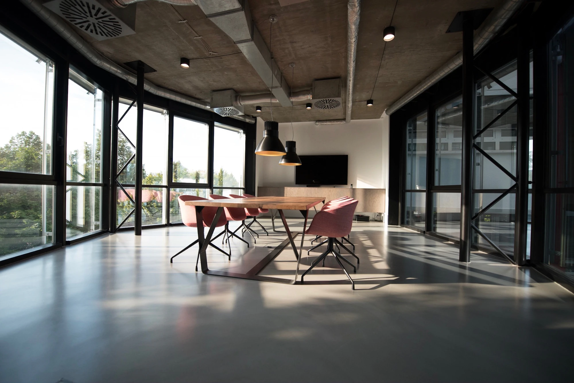 Office with glass walls, a long table and chairs