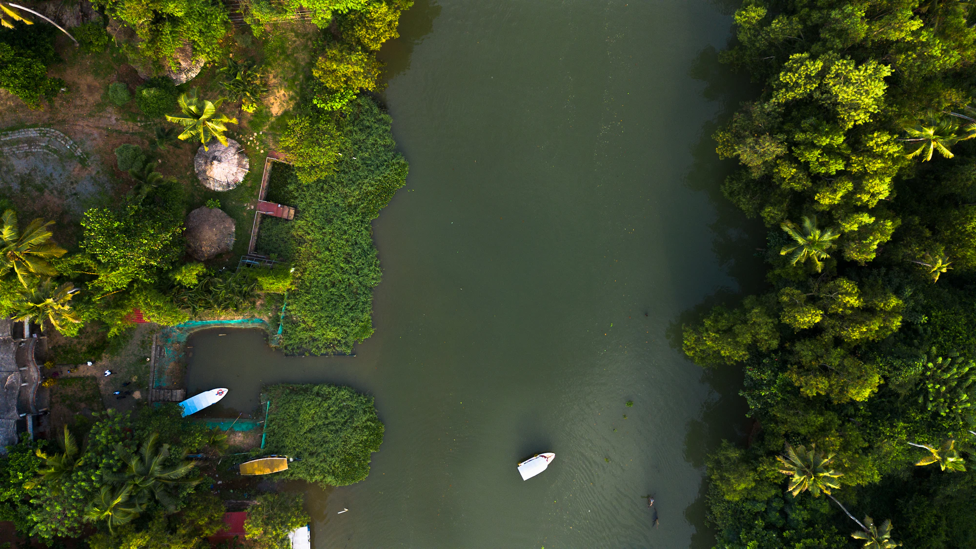 Aerial view of a backwater canal with small boats and trees